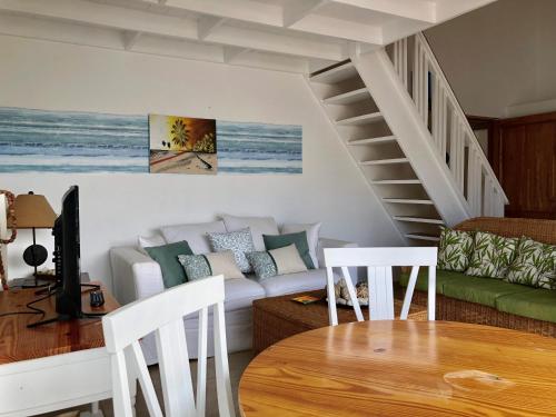 a living room with a couch and a table at Beach Day at CadaquesCaribe Bayahibe in Bayahibe