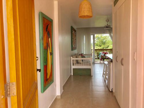 a hallway of a home with a view of a porch at Beach Day at CadaquesCaribe Bayahibe in Bayahibe
