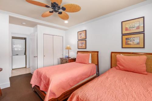 a bedroom with two beds and a ceiling fan at Luxury Poipu 4br Villa with AC Walk to the Beach! (224) in Koloa