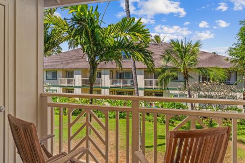 a view from the balcony of a resort with two chairs at Luxury Poipu 4br Villa with AC Walk to the Beach! (224) in Koloa
