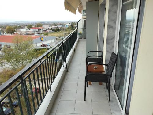 two chairs on a balcony with a view at Σαν Στο Σπίτι Σας in Xanthi