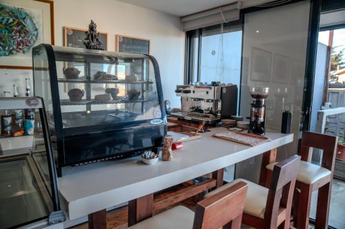a kitchen with a table with a glass display at Hotel Boutique Aldea del Mar in Pichilemu