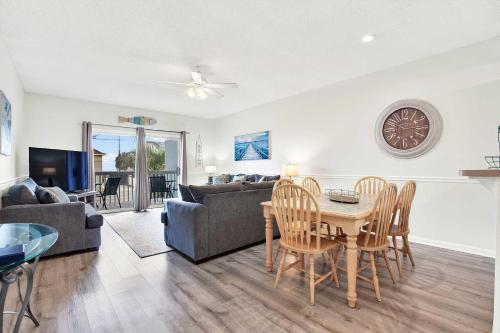 a living room with a table and a couch at Beach Point Villas Unit E in Tybee Island