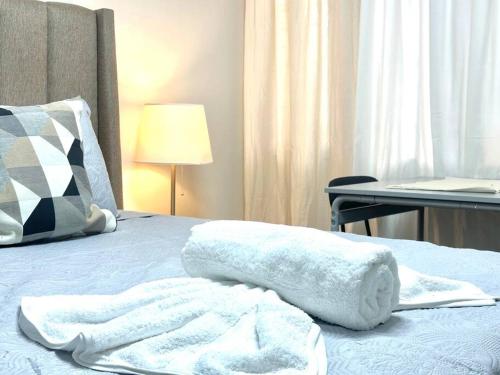 a white towel sitting on top of a bed at Villa Olímpica Doble Vía in Marilópez
