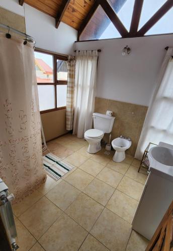 a bathroom with a toilet and a sink at Morada de los Legui in Ushuaia
