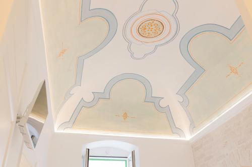 a bathroom with a wall with hearts and a mirror at Relais La Muraglia - Central Luxury Rooms - Molfetta in Molfetta