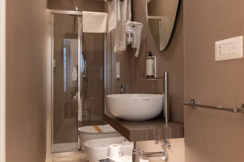 a bathroom with a sink and a toilet and a shower at Relais La Muraglia - Central Luxury Rooms - Molfetta in Molfetta