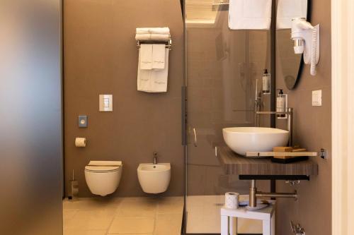 a bathroom with a toilet and a sink at Relais La Muraglia - Central Luxury Rooms - Molfetta in Molfetta
