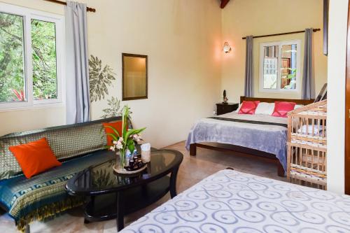 a living room with a couch and a bed at Hotel Anachoreo in Santa Fe