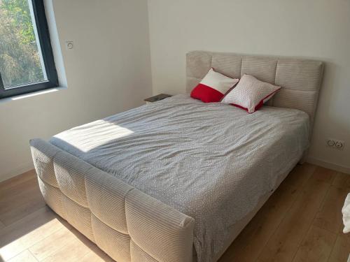 un lit avec deux oreillers dessus dans une chambre dans l'établissement Villa familiale avec piscine privée à Lutterbach, à Lutterbach