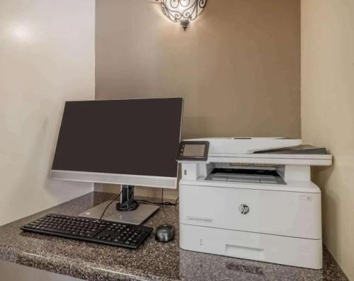 a computer monitor and a keyboard and mouse on a counter at Sonesta Simply Suites Las Vegas Convention Center in Las Vegas
