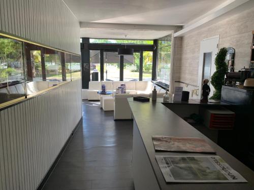 a lobby with couches and tables in a building at La Locomotive in Issoudun