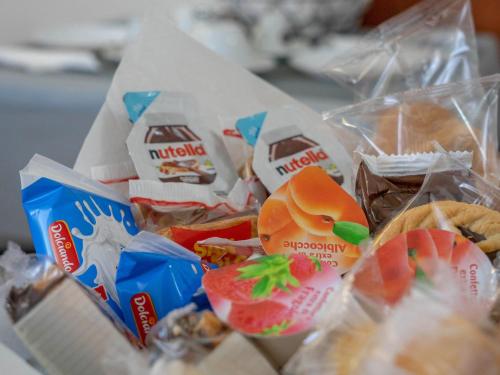a pile of food in plastic bags on a table at F.A.M. ROOMS in Ciampino