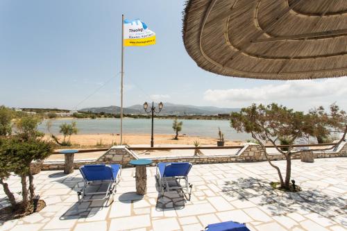 a table and chairs with a view of a beach at Theologos Beach in Antiparos Town