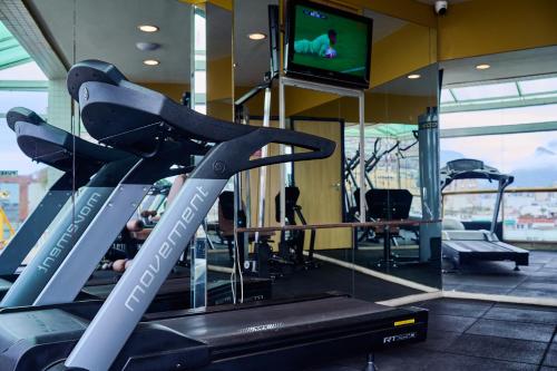 a gym with a treadmill and a flat screen tv at South American Copacabana Hotel in Rio de Janeiro