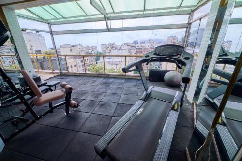 a gym with a treadmill and a chair in a building at South American Copacabana Hotel in Rio de Janeiro