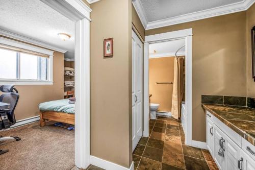 a bathroom with a sink and a toilet in a room at Winter Escape On Perfection - Ski In Out, Pool & Hot Tub in Big White