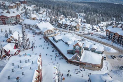 an aerial view of a ski resort in the snow at Winter Escape On Perfection - Ski In Out, Pool & Hot Tub in Big White