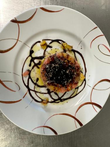 a white plate with a dessert with chocolate on it at La Locomotive in Issoudun