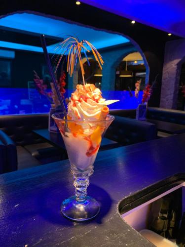 a dessert in a glass sitting on a table at La Locomotive in Issoudun