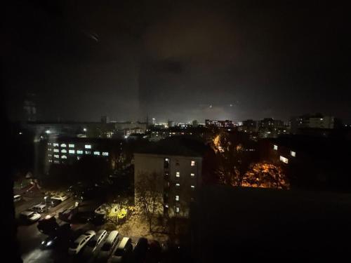 a view of a city at night at BDR residence in Craiova