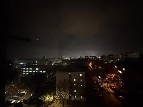 a city at night with a fire in the sky at BDR residence in Craiova