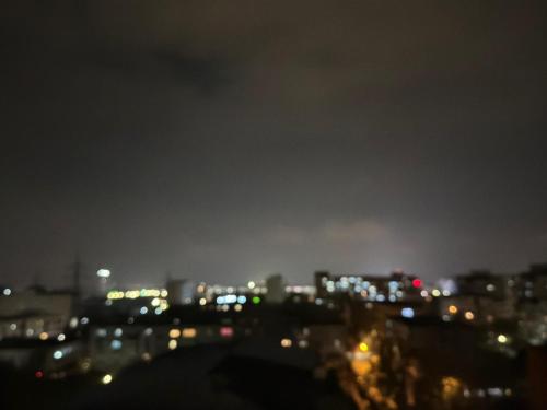 a view of a city at night at BDR residence in Craiova