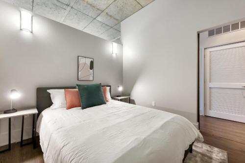 a bedroom with a large white bed and a window at Towers At Opop 703 Spacios And Cozy 1 Bd 1 B in Saint Louis