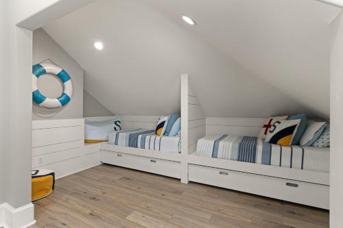 two beds in a room with white walls at Hook, Wine & Sinker - 20 Couper Place in Mallory Park