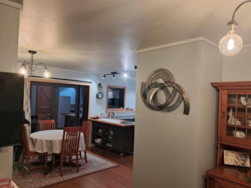 a kitchen and dining room with a table and a sink at Warm & welcome on Whiteley in New Plymouth
