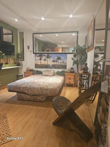 a bedroom with a bed and a large mirror at Tropical Room in Brussels