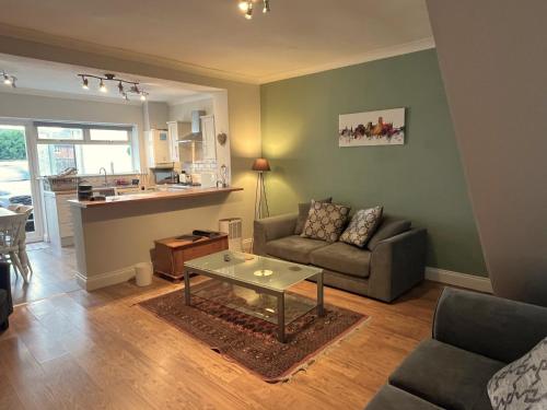 a living room with a couch and a table at Durham 3 Bedroom House With Parking in Durham