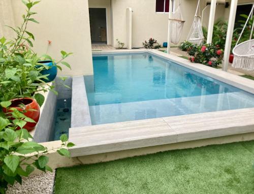 a swimming pool in the backyard of a house at Pierre and Colors TAMARINDO Adults only in Tamarindo