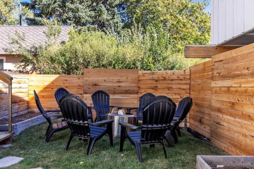 a patio with four chairs and a table in the grass at Hot Tub 4 Baths Montana Themed Bike To Downtown in Livingston