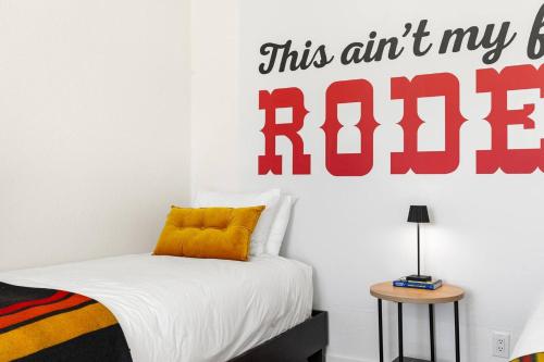 a bedroom with a bed with a sign that reads this art is radio at Hot Tub 4 Baths Montana Themed Bike To Downtown in Livingston