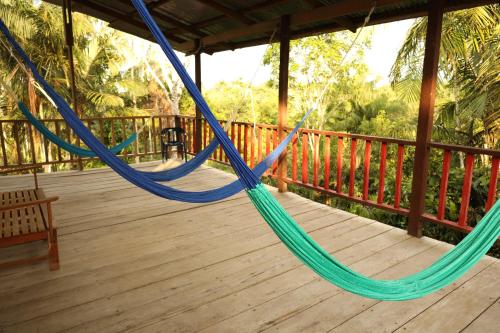 a porch with a hammock on a deck at La Ceiba, Amazonas in Leticia