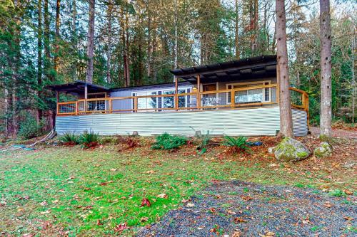a house in the middle of a forest at WatersView Tree House in Shelton