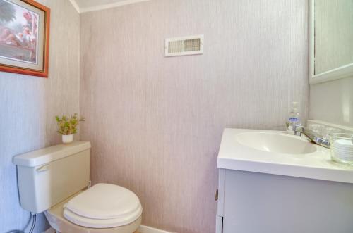 a bathroom with a toilet and a sink at 1 Mi to KFC Museum Corbin Getaway! in Corbin