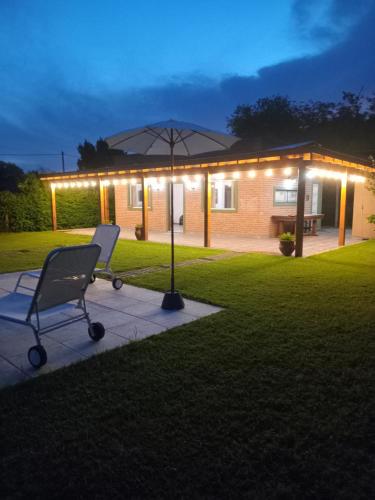 a chair in front of a house with lights at Sol y Luna in Mercedes