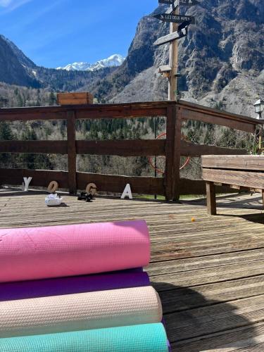 a stack of yoga mats on a deck with a bench at Hotel Au Bon Accueil in Les Deux Alpes