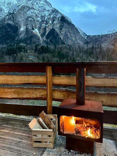 a fireplace on a deck with a view of a mountain at Hotel Au Bon Accueil in Les Deux Alpes