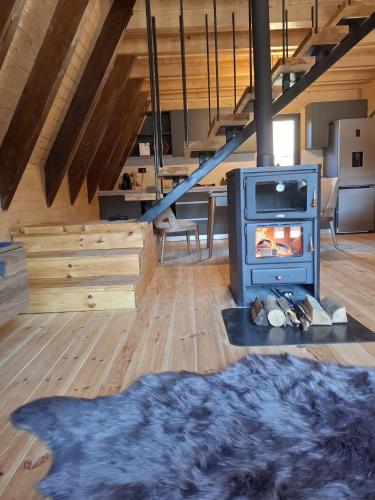 a living room with a fireplace and a stove at Duly Chalet in Kolašin