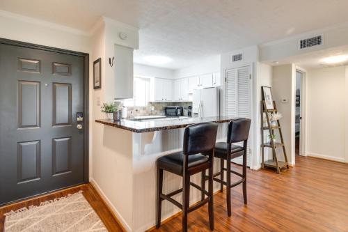 a kitchen with two bar stools and a counter at Waterfront Condo on Lake Conroe with Boat Launch! in Montgomery