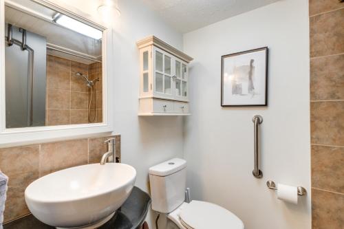 a bathroom with a white toilet and a sink at Waterfront Condo on Lake Conroe with Boat Launch! in Montgomery