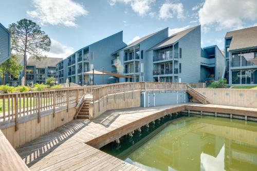 a pool of water in front of a building at Waterfront Condo on Lake Conroe with Boat Launch! in Montgomery