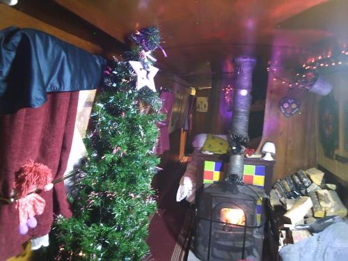 a room with two christmas trees and a fireplace at Rosie and Jim Retreat with hot tub indoors amazing in Lincoln
