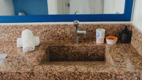 a sink in a bathroom with a counter top at La Mar de Bien in Buritaca
