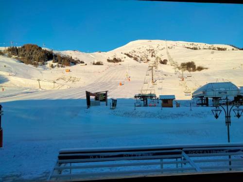 a snow covered ski slope with a ski lift at Appartement aux pieds des pistes - Apollo Le Corbier in Villarembert