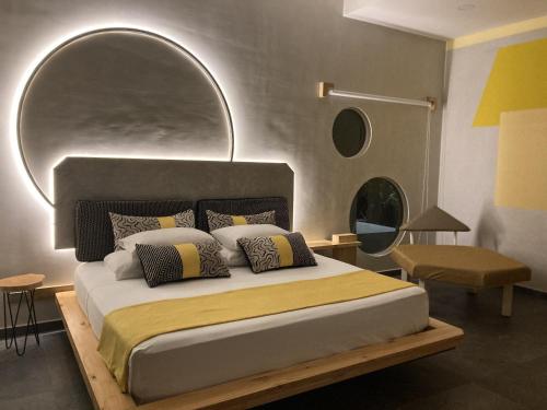 a bedroom with a large bed with a large mirror at Pierre and Colors TAMARINDO Adults only in Tamarindo