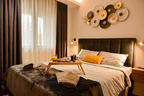 a bedroom with a bed with a table on it at Apartment Heart of Zlatibor - Central Residence in Zlatibor